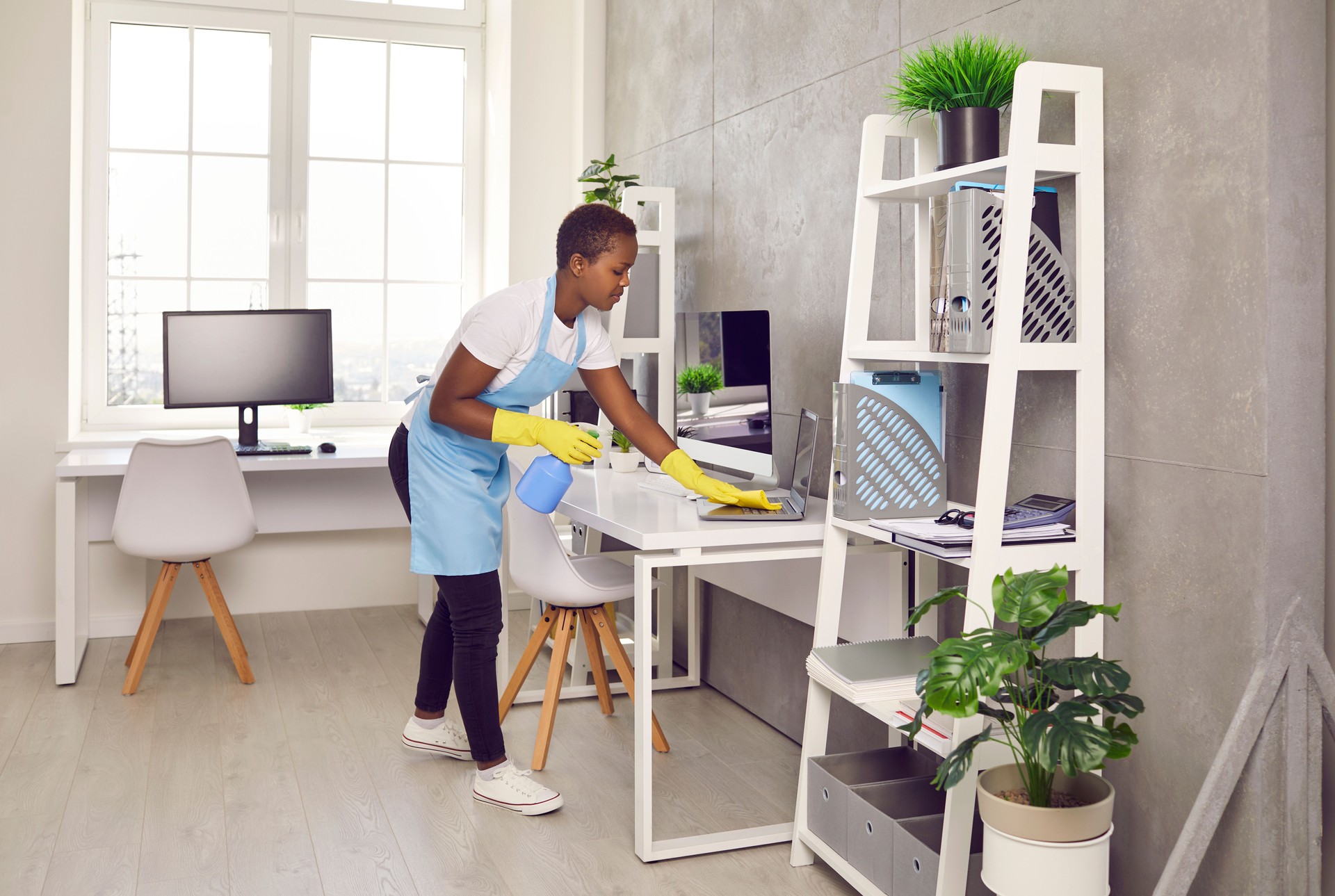 African American woman housekeeper clean office room